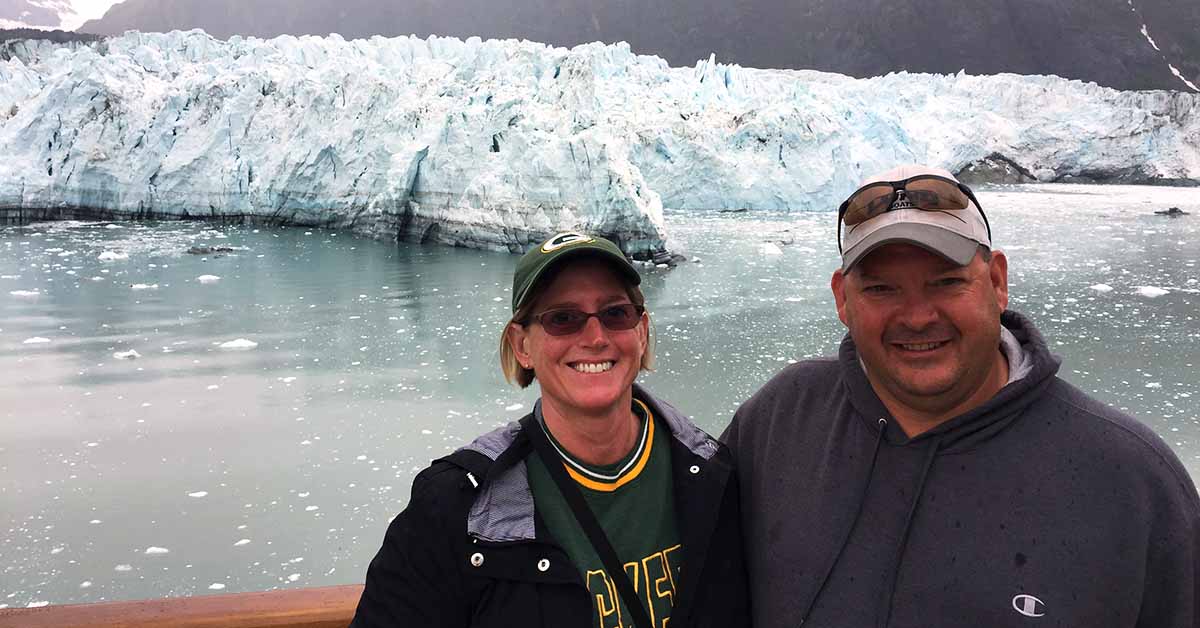 Ankle replacement patient Jim Lusardi and his wife in front of a glacier.