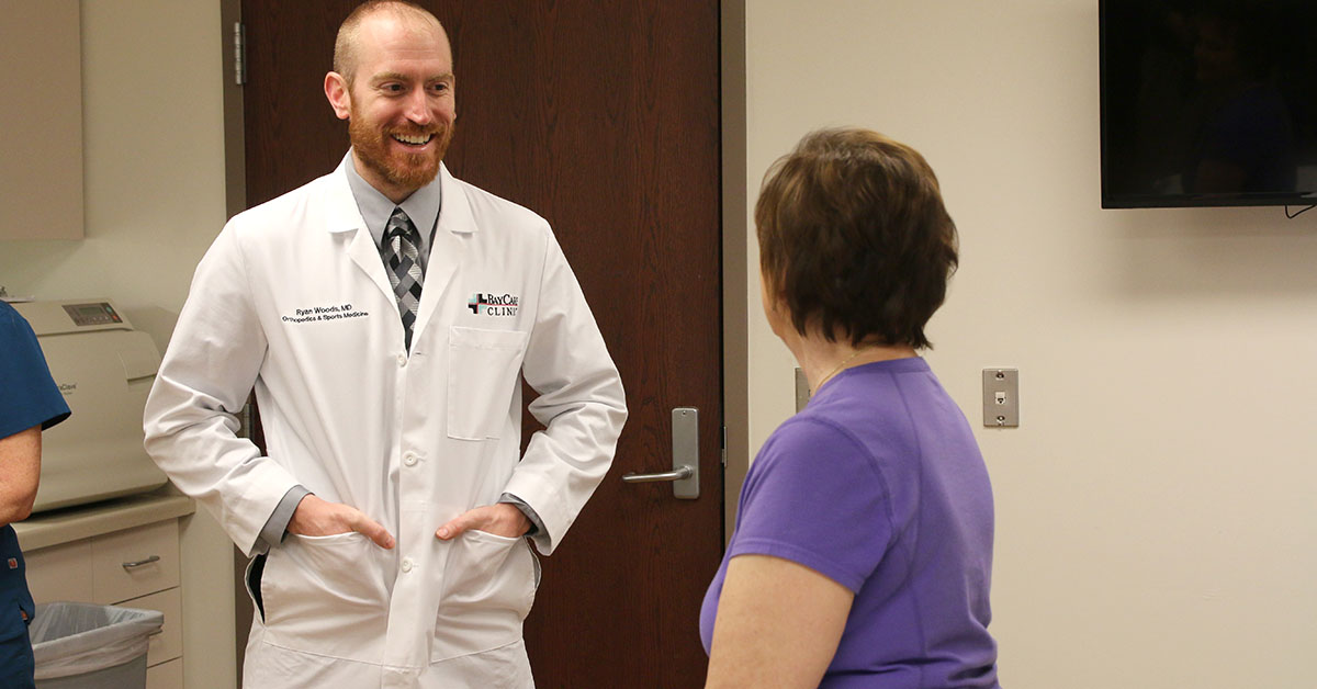 Dr. Ryan Woods talks with a patient