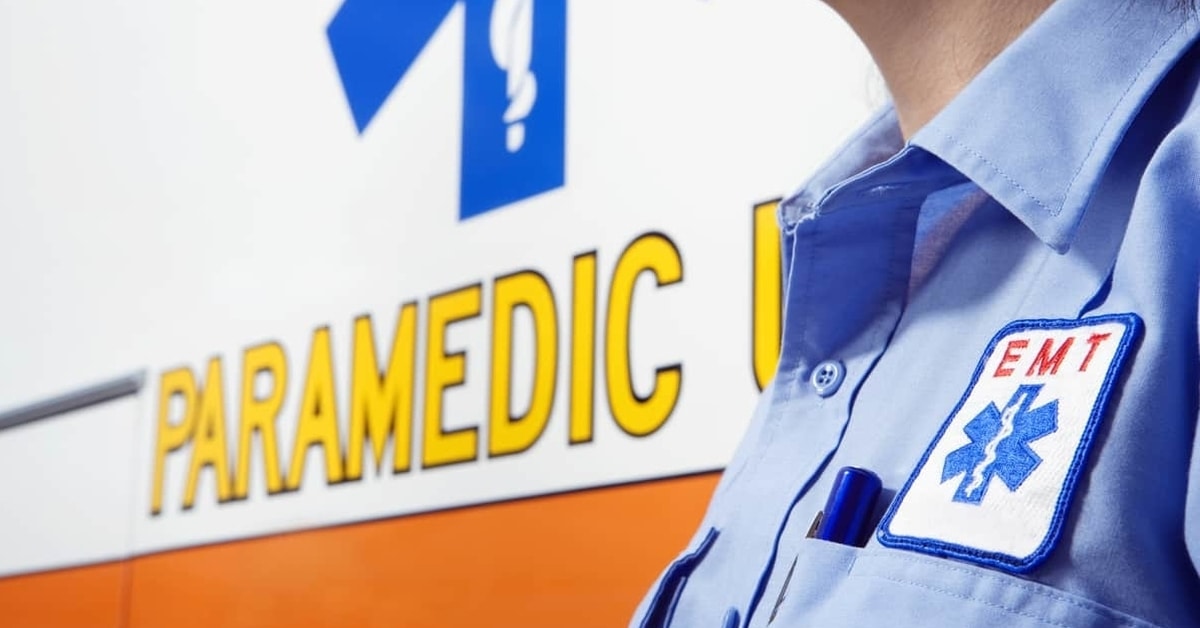Photo of an emergency medical services worker near an ambulance